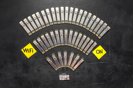 Electrical internet SFP network modules for network switch as wifi symbol and yellow stickers with title "WIFI on" on black backgroundの写真素材