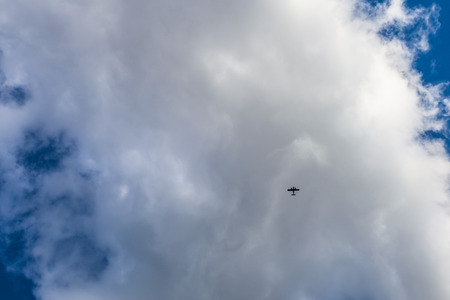 Blue sky with cloud closeup and planeの写真素材