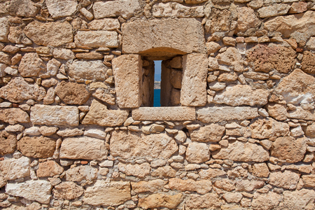 Rethymnon, Island Crete, Greece, - June 23, 2016: View on the stone wall with a narrow window of Fortezza Castle in Rethymnonのeditorial素材