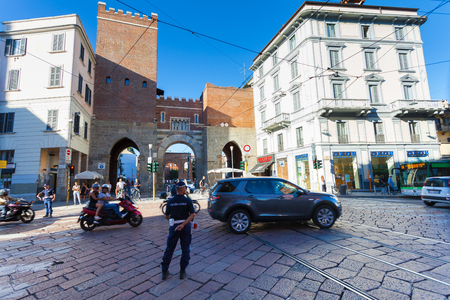 MILAN, ITALY - September 12, 2016: Policemen (Polizia Locale) are regulating traffic  near the medieval gate - Porta Ticinese Antica is located on the street Corso di Porta Ticineseのeditorial素材