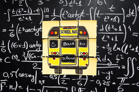 Back to school background with title Back to school and school bus  written on the yellow pieces of...