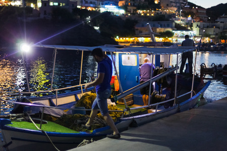 Bali, Island Crete, Greece, - June 30, 2016: Greek fishermen are leaving for night catching fish on the fishing boat from the small port located on Crete island in Greece.のeditorial素材