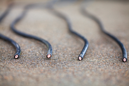 Four black coaxial cables are cut by vandals on the roof. Cutting of the cable tv vandalism concept....