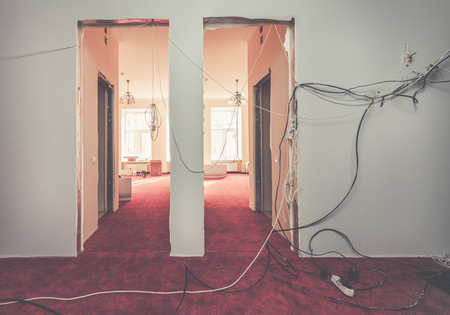 Interior of hall of apartment  with temporary electric wires   during  upgrade  or  remodeling, renovation, extension, restoration, reconstruction and construction. Picture with tone effect.の写真素材