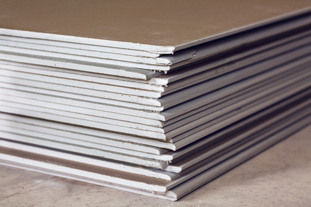 A lot of sheets of plasterboard or drywall close up in an apartment during on the construction, remodeling, rebuilding and renovationの写真素材