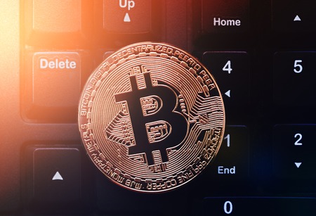 Bitcoin on keyboard. Physical bit coin. Digital currency. Cryptocurrency. Golden coin with bitcoin symbol.の写真素材