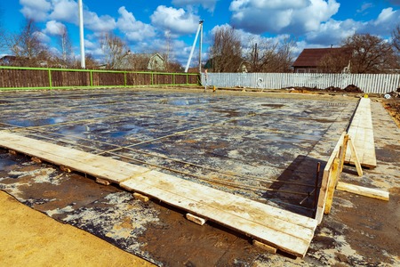 The building is under construction with new foundation after concrete pouring and making reinforcement metal framework and construction materials for thatの写真素材