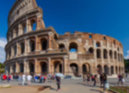 Blurred tourists visiting one of the famous sightseeing and monument in the world - Colosseum in Rome. Blurred background of travel concept  with bokeh effect.の写真素材