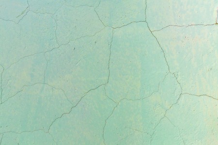Scratched painted cement wall with old color ragged plaster wall texture. Background of old painted wall.の写真素材