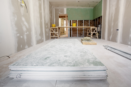 Working process of installing metal frames and plasterboard drywall for gypsum walls and materials in apartment is under construction, remodeling, renovation, extension, restoration and reconstructionの写真素材