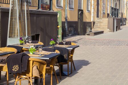 RIGA, LATVIA - MAY 06, 2017: View on the empty tables of street cafe or restaurant is located in the city center of Riga.のeditorial素材