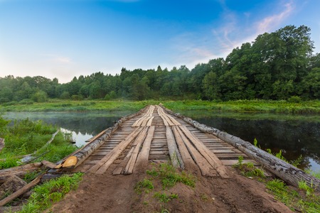 Temporary wooden bridge across river for heavy lorries, trucks, cars and vehicles  for carriage wood...