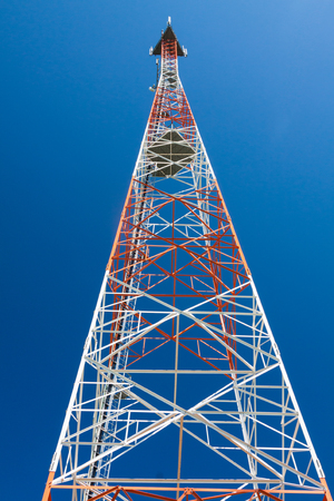 Telecommunications tower with microwave antennas and satellite dishes with cables and fiber optic.