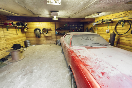 View of old  car in garage  with dusty hood dirty wind screen with title SALE by finger and broken windshield wiper. Concept of sale pre-owne cars.の写真素材