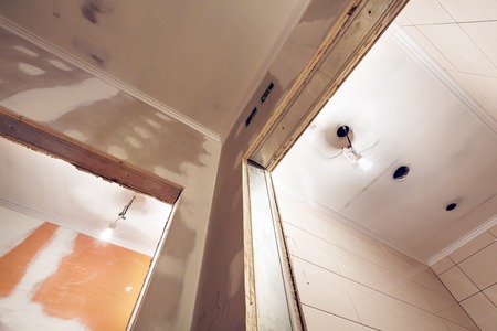 Working process of installing   plasterboard or drywall  for making gypsum walls  in apartment is under construction, remodeling, renovation, extension, restoration and reconstruction.  Concept of home improvement or renovate.の写真素材