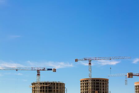 Industrial construction crane or column-jib crane with cabin works  on the construction site and...