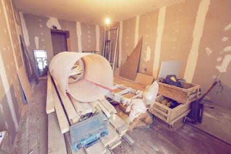 Working process of renovate room with installing drywall or gypsum plasterboard and construction materials are in apartment is under construction, remodeling, renovation, extension, restoration and reconstruction. Concept of home improvement or renovateの写真素材