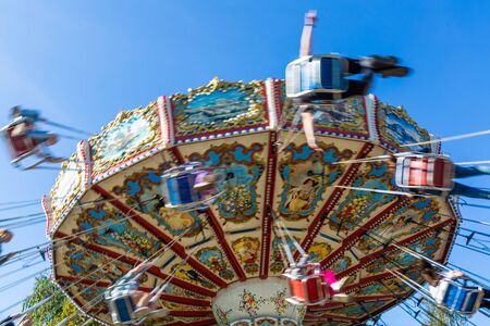Russia, Saint Petersburg - August 31, 2019: Divo Ostrov amusement park. Carousel with cheerful...