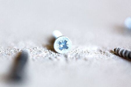 Image with sekected focus on the some screws are on the working surface for plasterboard - drywall...