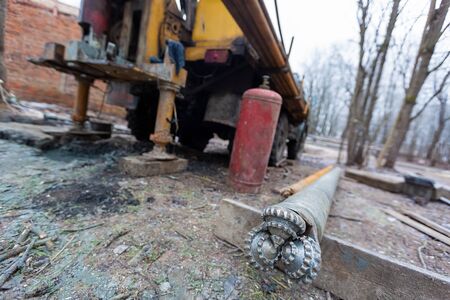 feed-screw from Hydraulic ground water hole drilling machine installed on the old truck with big...