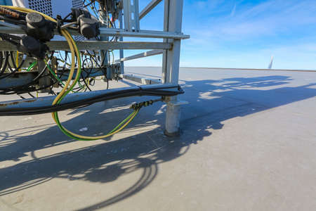 Russia, Saint-Petersburg - March 29, 2019: Cables of Base Transceiver Station (BTS) are installed on top of a building. Outside part 5G, 4G, 3G, 2G basic station.のeditorial素材