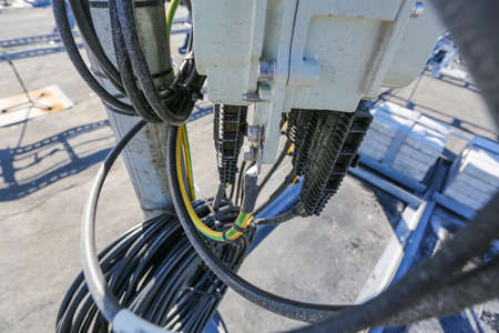 Russia, Saint-Petersburg - April 30, 2018: Outdoor remote radio unit (RRU) and cables of Base Transceiver Station (BTS) are installed on top of a building. Outside part 5G, 4G, 3G, 2G basic station.のeditorial素材