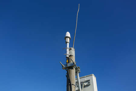 Russia, Saint-Petersburg - April 30, 2018: Panel antenna of 5G, 4G, 3G, 2G bands, optical fibers, power cables and outdoor remote radio units are as part of communication equipment of basic telecommunication station are installed on the roof. Outside partのeditorial素材