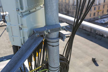 Russia, Saint-Petersburg - April 30, 2018: Mounting of Outdoor remote radio unit (RRU) and cables of Base Transceiver Station (BTS) are installed on top of a building. Outside part 5G, 4G, 3G, 2G basic stationのeditorial素材