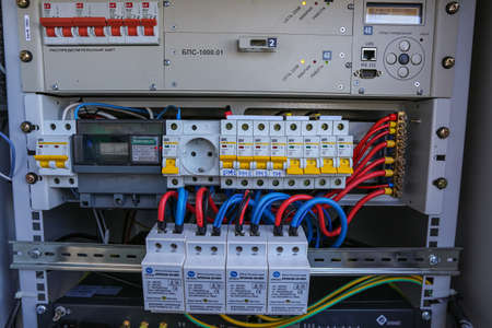 Russia, Saint-Petersburg - April 30, 2018: Inside part of climatic vandal-proof cabinet with microwave equipment and power cables, coaxial cables, optic fibers. Typical basic station of telecommunication operators.のeditorial素材