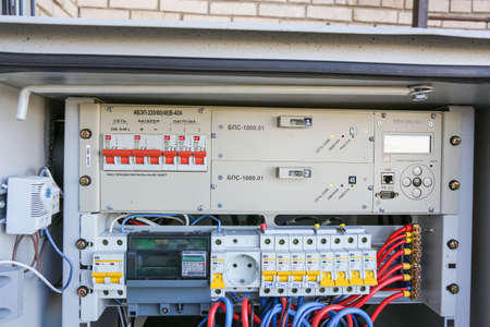 Russia, Saint-Petersburg - April 30, 2018: Inside part of climatic vandal-proof cabinet with microwave equipment and power cables, coaxial cables, optic fibers. Typical basic station of telecommunication operators.のeditorial素材