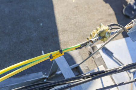 Russia, Saint-Petersburg - April 30, 2018: Ground cables of Base Transceiver Station (BTS) are installed on top of a building and grounding to outdoor lightning rod . Outside part 5G, 4G, 3G, 2G basic station.のeditorial素材