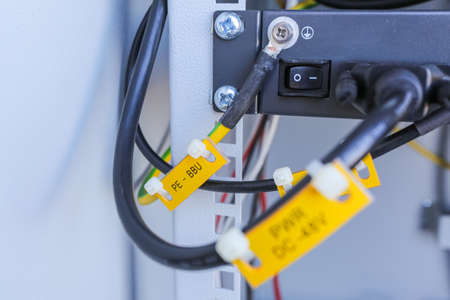 Russia, Saint-Petersburg - April 30, 2018: Inside part of climatic vandal-proof cabinet with microwave equipment and power cables, coaxial cables, optic fibers. Typical basic station of telecommunication operators.のeditorial素材