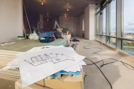 Construction documentation with details, marked by measurements, construction and design details in engineer hand and corridor with windows, doors, in an apartment during on the construction,overhaul, remodeling, rebuilding, home improvements and renovation.の写真素材