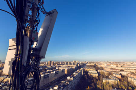 Radio panel antenna with outdoor radio unit and power cables, coaxial cables, optic fibers on the...