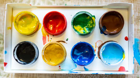 Top view of the bright colorful paints in paper box, close upの写真素材