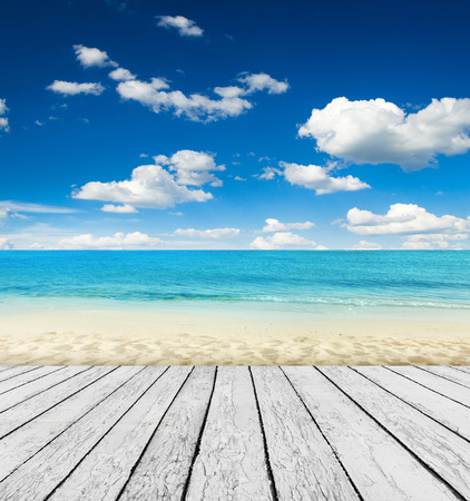 Empty wooden pier beside tropical beachの写真素材