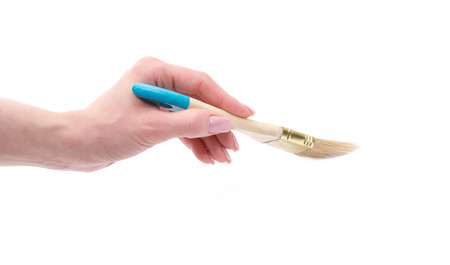 hand holding paint brush isolated over white backgroundの写真素材