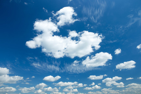 white fluffy clouds in the blue skyの写真素材