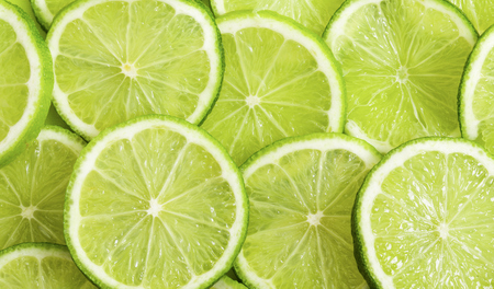 Green background with citrus-fruit of lime slicesの写真素材