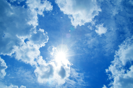 Blue sky with clouds and sun.の写真素材