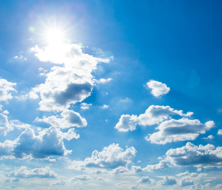 white fluffy clouds in the blue skyの写真素材