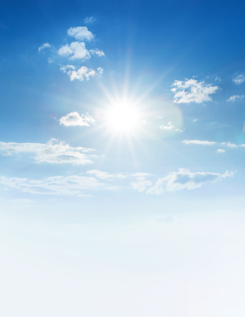 Blue sky with clouds and sun.