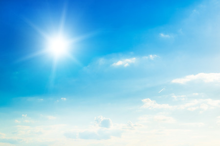 Blue sky with clouds and sun.の写真素材
