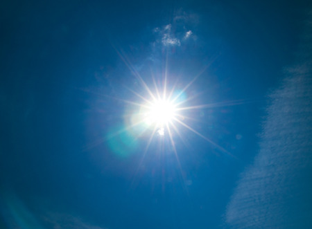 Shining sun at clear blue sky with copy spaceの写真素材