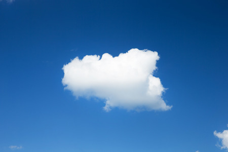 white fluffy clouds in the blue skyの写真素材