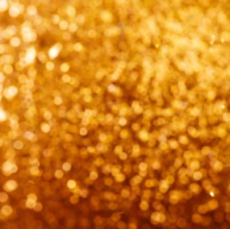 Defocused Bokeh twinkling lights Vintage background. Festive background with natural bokeh and bright golden lights.の写真素材