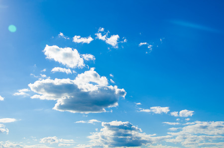 white fluffy clouds in the blue skyの写真素材