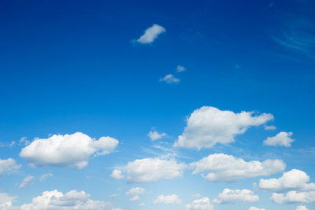 white fluffy clouds in the blue skyの写真素材