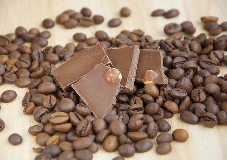 Coffee grains and chocolate on wooden background の写真素材