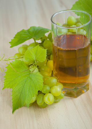 white grapes juice on a wooden backgroundの写真素材